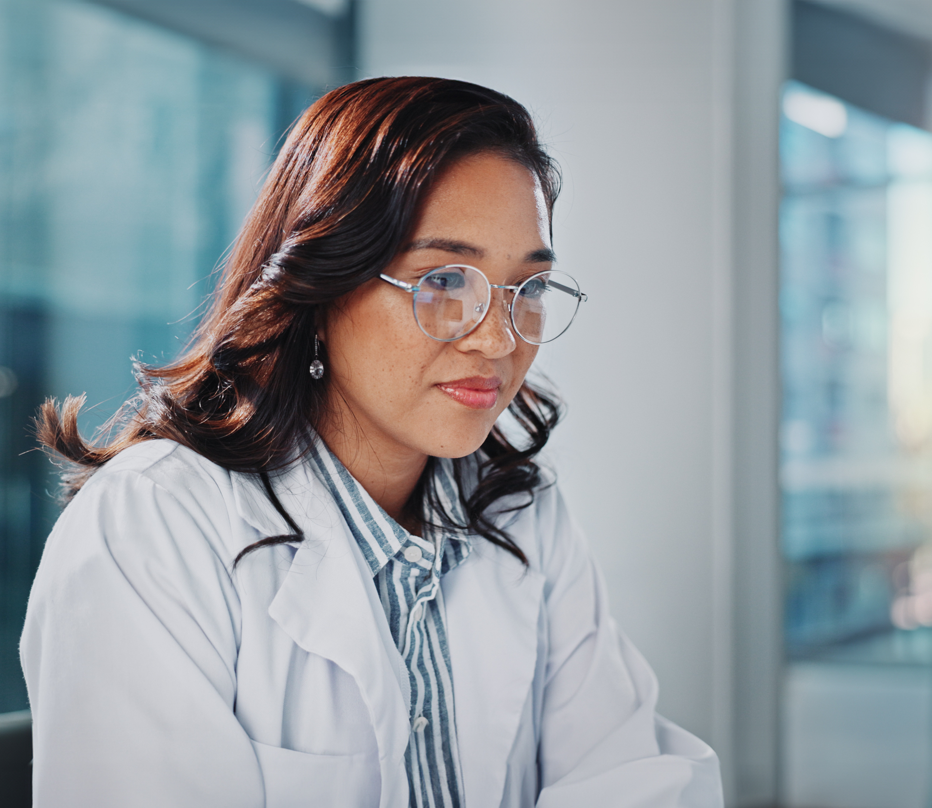 Female HCP reading screen in clinic